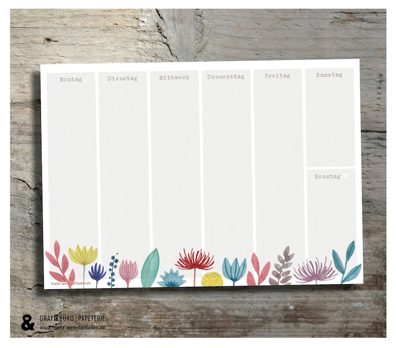 May include: A weekly planner with a floral border. The planner is divided into seven sections for each day of the week: Monday, Tuesday, Wednesday, Thursday, Friday, Saturday, and Sunday. The planner is printed on white paper with a light grey background.