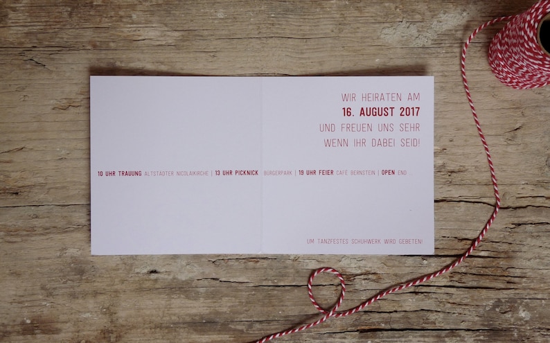 May include: A pink wedding invitation card with red text. The text reads "We are getting married on August 16, 2017 and we are very happy if you can be there!"  The card also includes details about the wedding ceremony, picnic, and reception.