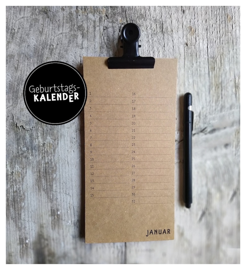 May include: A brown paper calendar with a black clip at the top. The calendar is labeled "Geburtstags-KALENDER" and has the month of January listed. The numbers 1 through 31 are listed on the left side of the calendar, and the numbers 16 through 31 are listed on the right side of the calendar.