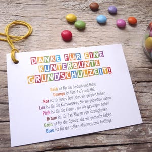 May include: A colorful card with the text "DANKE F&Uuml;R EINE KUNTERBUNTE GRUNDSCHULZEIT!" and a list of colors with their meanings. The colors are yellow, orange, red, purple, pink, brown, green, and blue.