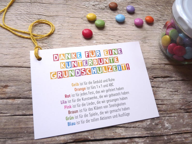 May include: A colorful card with the text "DANKE F&Uuml;R EINE KUNTERBUNTE GRUNDSCHULZEIT!" and a list of colors with their meanings. The colors are yellow, orange, red, purple, pink, brown, green, and blue.