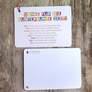 May include: A colorful thank you card with the text "DANKE F&Uuml;R DIE KUNTERBUNTE ZEIT!" and a description of what each color represents. The card is on a wooden surface.