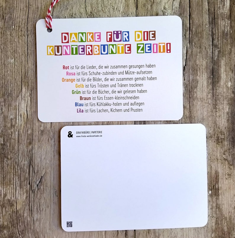 May include: A colorful thank you card with the text "DANKE F&Uuml;R DIE KUNTERBUNTE ZEIT!" and a description of what each color represents. The card is on a wooden surface.