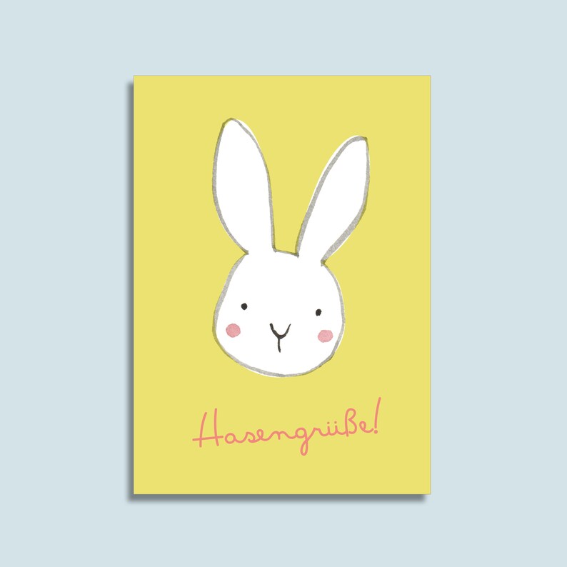 Peut inclure: Une carte jaune avec une illustration de lapin blanc et le texte "Hasengr&uuml;be!" en rose.