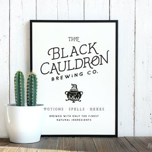 May include: A black and white printable sign with the text "The Black Cauldron Brewing Co." and a black cauldron with steam coming out of it. The text below the cauldron reads "Potions Spells Hexes Brewed with only the finest natural ingredients."