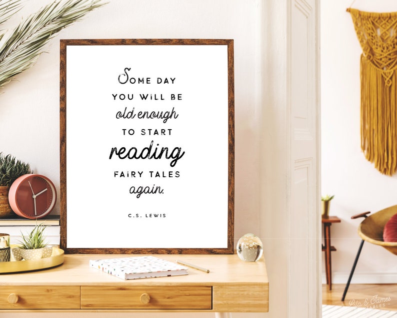 May include: A framed print with a brown wooden frame and a white background. The print features a black and white quote that reads "Some day you will be old enough to start reading fairy tales again. C.S. Lewis".