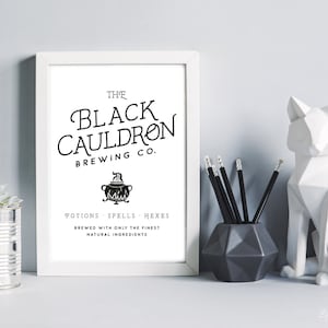 May include: A printable black and white graphic with the text "The Black Cauldron Brewing Co." and a cauldron with flames. The text below the cauldron reads "Potions Spells Hexes Brewed with only the finest natural ingredients."