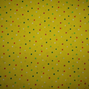 Yellow cotton fabric with colorful dots