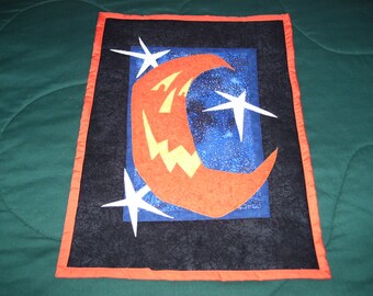 Halloween pumpkin moon just in time for Halloween fun. It is machine quilted and appliqued and ready to hang!