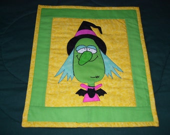 A witch is on this cute quilt for Halloween fun. It is machine quilted and ready for hanging.