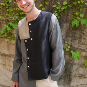 May include: A colour-block long-sleeved shirt with a distinctive design. The shirt has a black panel, a grey sleeve, and a beige panel. It features a button-up closure and is worn with off-white trousers. The brand name "DongoDesign" is visible.