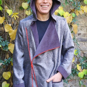 May include: A gray hooded jacket with a red zipper and a purple lining. The jacket has a zippered pocket on the left side. The jacket is made of a soft, comfortable fabric. DongoDesign is printed on the bottom right corner of the image.