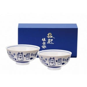 May include: A set of two white ceramic bowls with a blue rim and a repeating pattern of a beckoning cat. The bowls are presented in a dark blue gift box with gold Japanese characters.