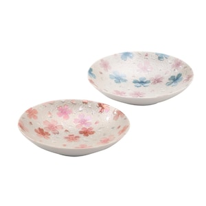 May include: Two white ceramic bowls with floral patterns. One bowl has pink and red flowers, the other blue and pink. The bowls have a textured, speckled look, suitable for serving small portions. Each bowl is approximately 15 cm in diameter.