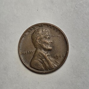 May include: A copper-colored 1946 United States one-cent coin featuring the profile of Abraham Lincoln facing right. The text IN GOD WE TRUST is arched across the top, with LIBERTY on the left and the year 1946 printed on the right side.