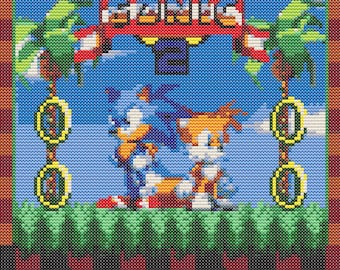 May include: A pixelated image of Sonic the Hedgehog and Tails from the video game Sonic the Hedgehog 2. The characters are standing on a green platform with a blue sky and palm trees in the background. The game title "SONIC 2" is displayed above the characters.