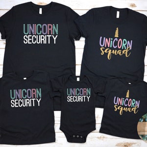 May include: Black t-shirts with a unicorn theme. The shirts say "Unicorn Security" and "Unicorn Squad" in colorful text.