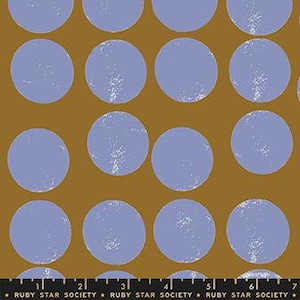May include: A fabric with a repeating pattern of large, blue circles on a mustard yellow background. The circles have a white speckled texture.
