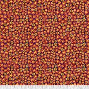 May include: A fabric featuring a repeating pattern of orange and yellow starbursts and circles on a dark red backdrop. The design is closely packed, covering the entire surface. A ruler is visible at the bottom.