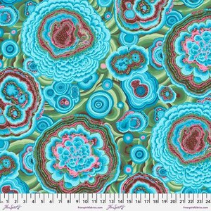 May include: Abstract fabric with a repeating pattern of blue, green and pink agate-like shapes. The fabric has a textured, almost 3D appearance.