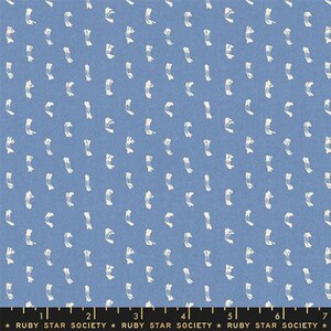 May include: A blue fabric with a white repeating pattern of small, stylised lines. The fabric has a subtle texture and a slightly faded look.