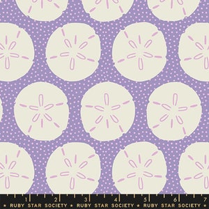 May include: Purple fabric with a white background and a repeating pattern of sand dollars with pink centers. The fabric has a small white polka dot pattern.