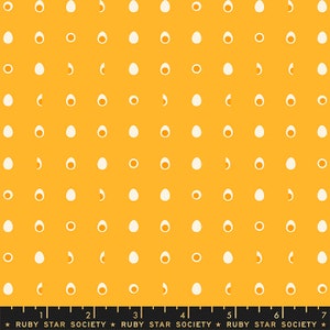 以下が含まれることがあります： 黄色い生地に白い卵の繰り返し模様がプリントされています。生地の下部には、"Ruby Star Society"という文字が繰り返された定規が印刷されています。