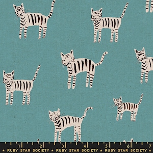 May include: Teal fabric with a repeating pattern of cartoon cats. The cats are white with black stripes. The text "RUBY STAR SOCIETY" is printed along the bottom edge of the fabric. The design is playful and suitable for various craft projects.