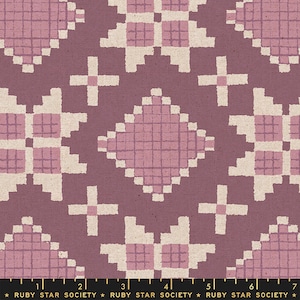 May include: A pink and white geometric pattern fabric with a repeating design of squares and crosses. The fabric has a textured surface and a subtle sheen.