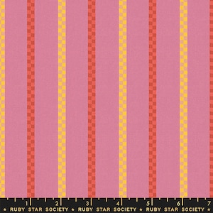 May include: Pink fabric with vertical stripes in yellow, orange, and red. The stripes are made up of small squares. The fabric is marked with a ruler and the text "RUBY STAR SOCIETY".