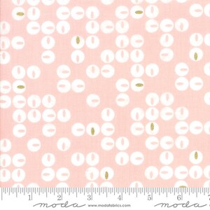 以下が含まれることがあります： ピンクの生地に白と金のドット柄がプリントされています。生地には「moda」という文字が印刷された定規が付いています。