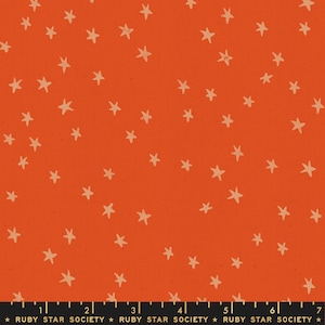 May include: Orange fabric featuring a random pattern of light tan stars. The material has a textured finish. The text "RUBY STAR SOCIETY" is printed along the bottom edge.