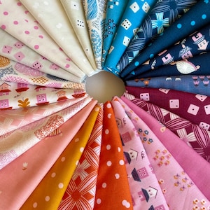 May include: A collection of 18 fabric swatches featuring various patterns and colours, including pink, blue, orange, and white. The fabrics are arranged in a circle, with the edges of each swatch overlapping.