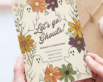 May include: A rectangular invitation card with a cream background featuring white ghost illustrations and colorful flowers in orange, yellow, purple, and green. The text reads: Let's go, Ghouls! REAGAN IS TURNING NINE! October 15 at 2 p.m. Reagan's House RSVP to Laura at 949-930-2970.