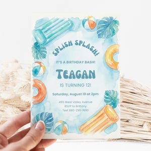 May include: A white ceramic mug with a black handle and the text "But First, Coffee" in a bold, black font. The mug is set against a neutral background, highlighting its simple design.