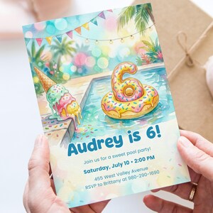 May include: A watercolour invitation for a pool party. The invitation shows an ice cream cone and a donut-shaped float in a pool. Text reads "Audrey is 6!" and includes party details. Held by a person.