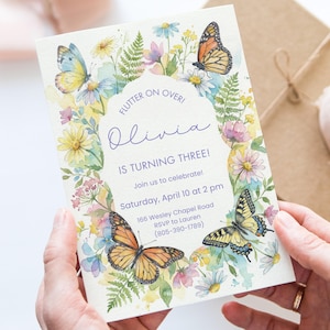 May include: A birthday invitation with a watercolour design of butterflies and flowers. The invitation text reads "FLUTTER ON OVER! Olivia IS TURNING THREE!" with event details. The design includes yellow, blue, and orange butterflies and floral accents.