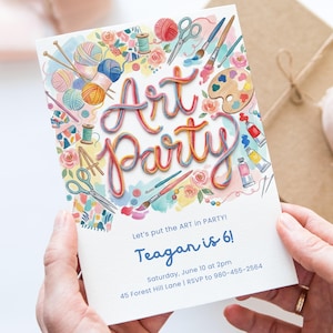 May include: An invitation for an art-themed party. The card features the words "Art Party" in colorful, whimsical lettering. Illustrations of art supplies like paint tubes, paint palettes, and yarn surround the text. The invitation is held by a person.