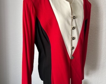May include: A long-sleeved blazer featuring a color-blocked design with vibrant red side panels, black accents, and a central white V-shaped panel. The garment is secured with five circular gold-toned buttons down the front center.