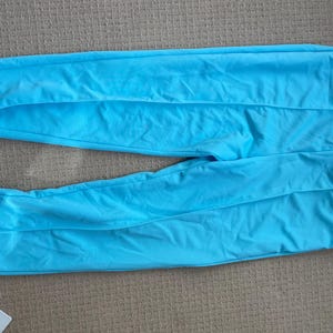 May include: A pair of light blue sweatpants with a straight leg and a drawstring waist.