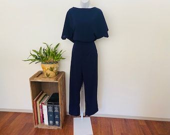 Navy Blue early 1980s jumpsuit. One piece poly romper. Oversized top. Curvy bottom. Classic 1980s piece. size Large. Key holed back.