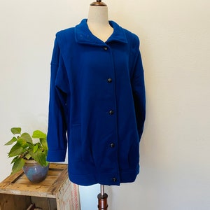 1980s wool Blue wool coat. International Scene. Size medium to large. European Wool Coat. Bright Blue. Warm. Fashionable. Lined. Pockets.