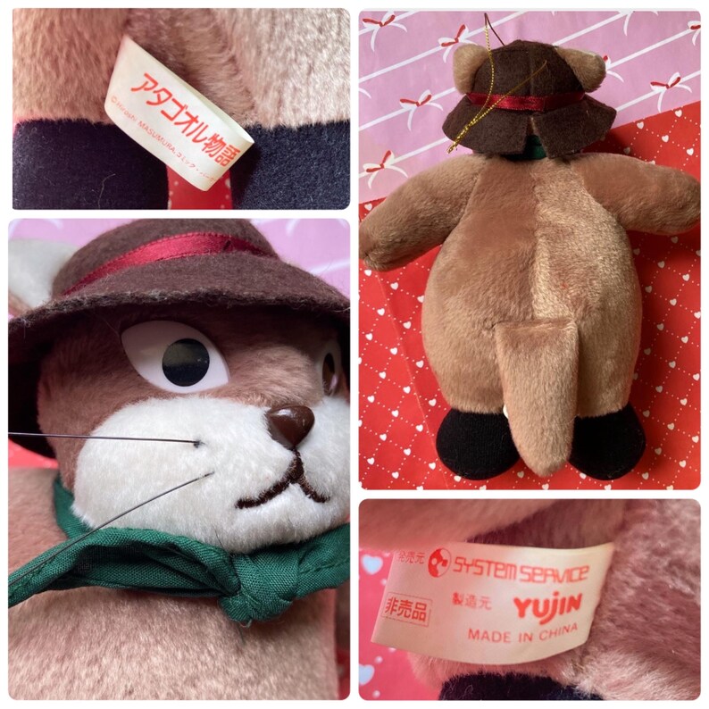 May include: A plush toy rabbit with a brown hat, green scarf, and black shoes. The rabbit has large eyes and a stitched nose and mouth. The toy has a tag with Japanese text.