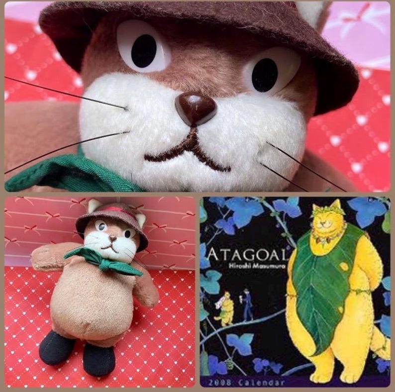May include: A plush toy cat with a brown hat, green bow tie, and black shoes. The image also includes a close-up of the cat's face and a calendar page with the text "ATAGOAL" and a cartoon illustration of a cat.