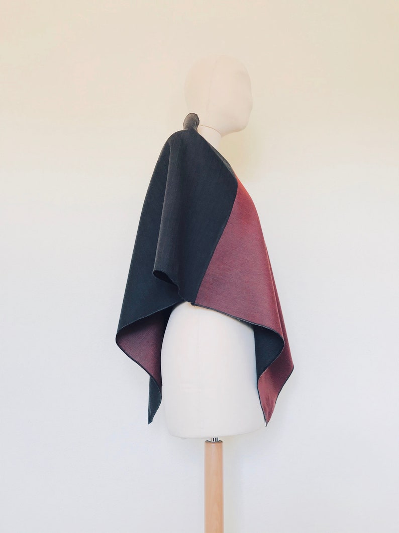 Fashionable wool cape in red and grey tones