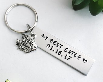 May include: Silver keychain with a small fish charm and a rectangular tag that reads "My Best Catch # 01.16.17" with a heart symbol.