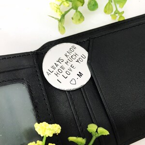 May include: A silver-toned metal token with the inscription "Always know how much I love you -M" and a small heart symbol.