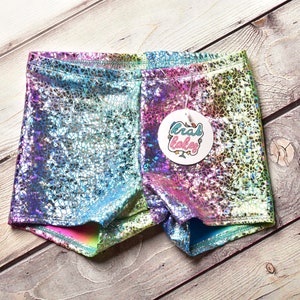 May include: Rainbow iridescent shorts with a holographic finish. The shorts have a tag that says "crab cakes".