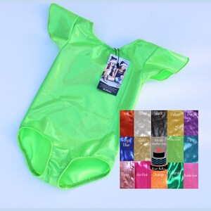 May include: A bright green leotard with short sleeves and a scoop neck. The leotard is made of a shiny, sparkly fabric. The leotard is shown on a white background with a color chart of different fabrics.