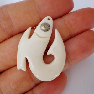 Conch eye and bone fish hook pendant . B25
